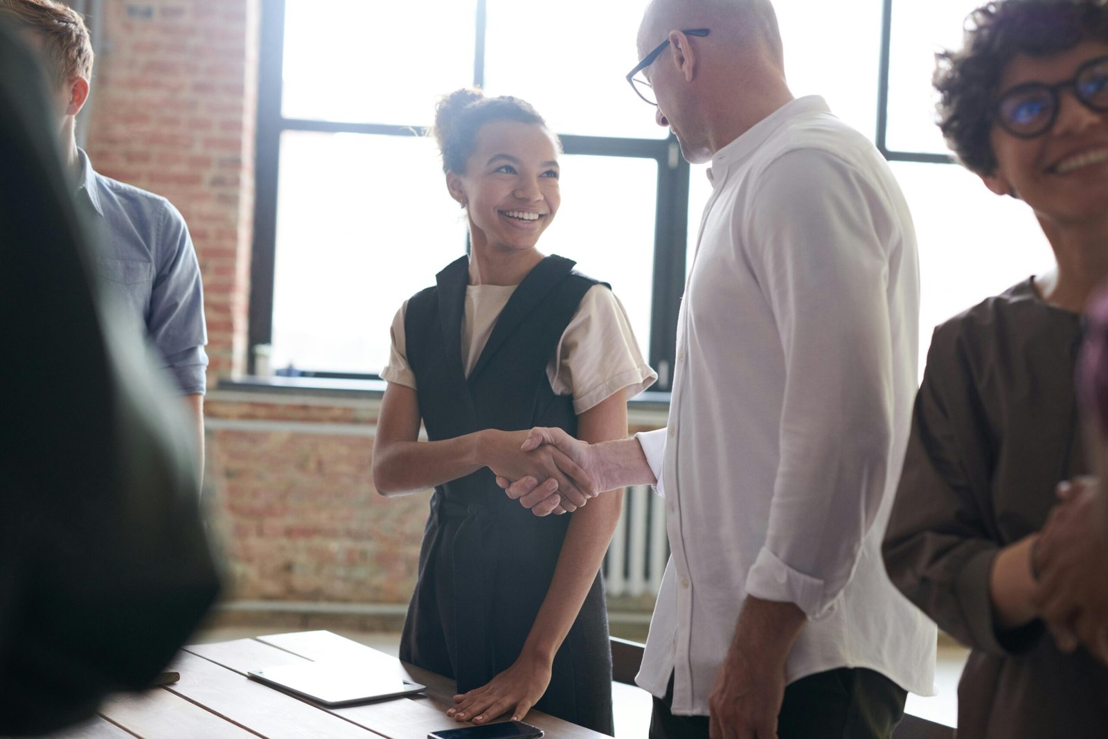 group of enthusiastic businesspeople fist bumping showing solidarity and support